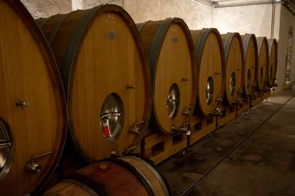 Stages of wine production from fermentation to bottling, visit to wine cellars in Cote d\'Or, Burgundy, France, Aging in wooden barrels.