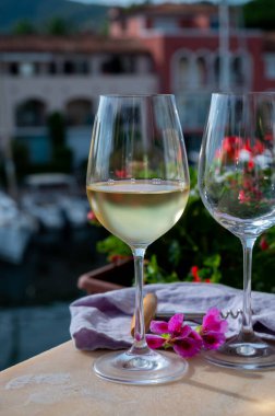 Drinking of cold white wine  with view on yacht harbour of Port Grimaud, summer vacation on French Riviera in Provence, France