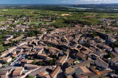 Aerial vIew on medieval buildings and vineyards in sunny day, vacation destination, famous wine making village Chateauneuf-du-pape in Provence, France