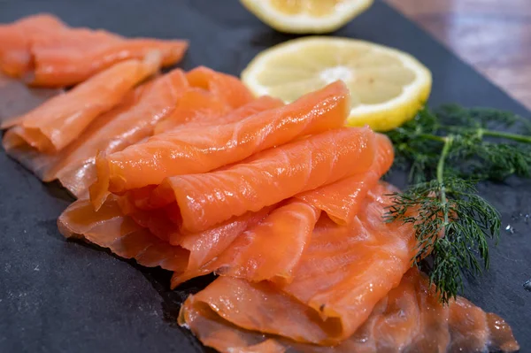 Slices Tasty Smoked Scottish Salmon Fish Served Black Plate Lemon — Zdjęcie stockowe
