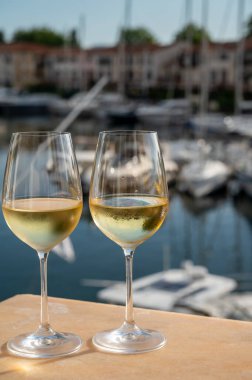 Port Grimaud 'un yat limanında manzaralı soğuk beyaz şarap içmek, Fransa' nın Provence şehrinde Fransız Rivierası 'nda yaz tatili