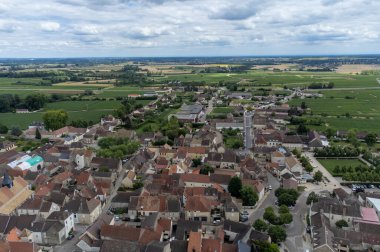 Aerial view on green vineyards and Puligny-Montrachet village, production of high quality famous French white wine in region Burgundy, France