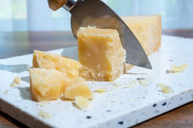 Italian cheese collection, piece of old matured grana padana cheese made from cow milk in Italy, close up