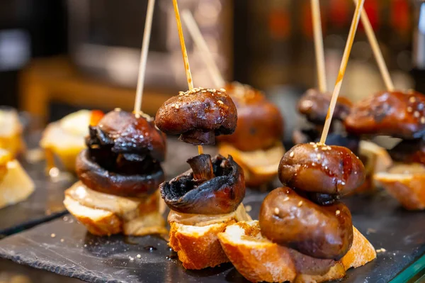 Typical snack in bars of Basque Country and Navarre, pinchos or pinxtos, small slices of bread upon which ingredient or mixture of ingredients is placed and fastened with skewers, San Sebastian, Spain, close up