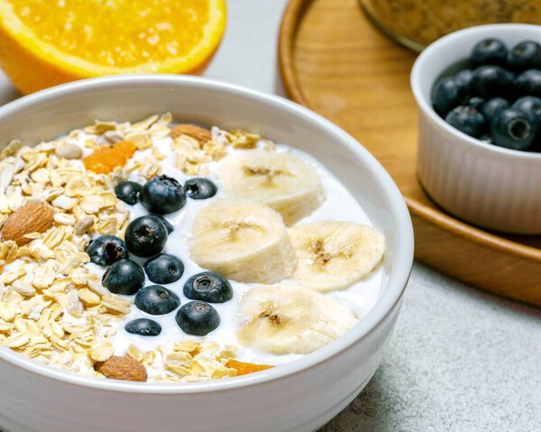 Muesli Cereal with Blueberry, Banana, almond milik, and Sunkist for healthy breakfast