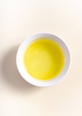 Eggs whites in a white bowl isolated on broken white