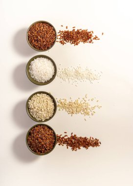 Mixed raw rice on white table. Vertical. Top view. Place for text. Copy space.