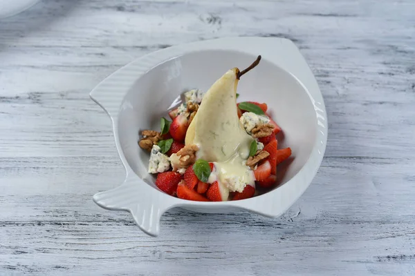 pear in sweet sauce with strawberries, nuts and dor blue cheese