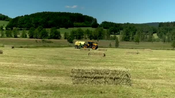 Tractor Collects Grass Releases Bales — ストック動画