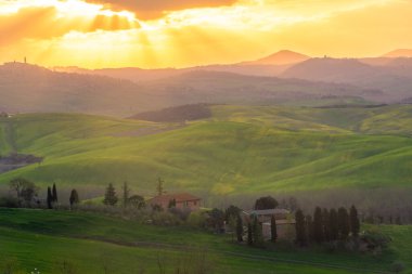 Amazing sunrise over the green hills of the Tuscany countryside, Italy