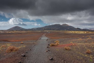 Wild volcanic landscape of Los Volcanes Natural Park in Lanzarote, Canary Islands, Spain