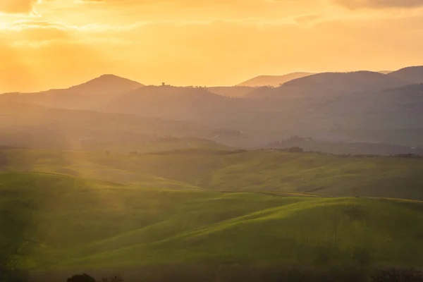 Amazing sunrise over the green hills of the Tuscany countryside, Italy