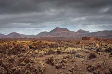 Wild volcanic landscape of Los Volcanes Natural Park in Lanzarote, Canary Islands, Spain