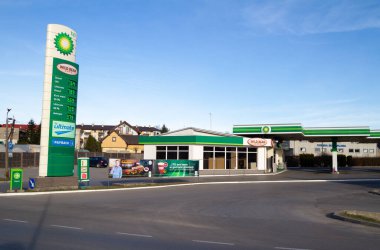 Skawina, Poland - March 27, 2022: BP petrol station and Wild Bean Cafe. British Petroleum oil company gas station, forecourt pylon with logo and prices displayed.