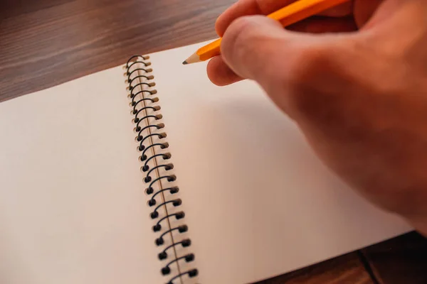 彼はスケッチブックに鉛筆で絵を描く — ストック写真