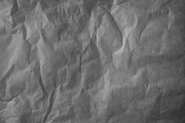 Black and white paper background, crumpled paper.