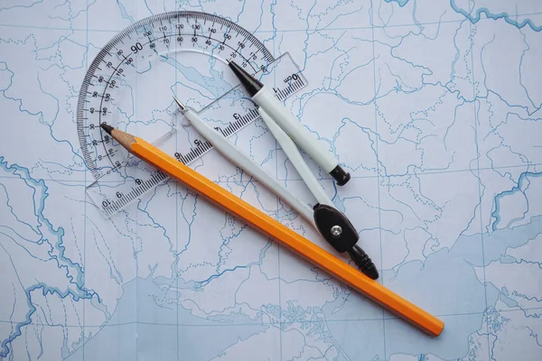 Top view topographic map. Blueprints. Pencil compasses and ruler on a topographic map. Pencil compass and ruler. Back to school.
