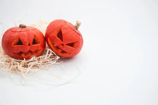 Halloween decoration. Halloween pumpkin. Carved pumpkin. Two pumpkins on a white background. Happy Halloween holiday concept.