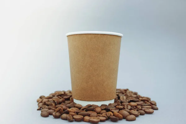 Mockup image of a paper cup with a lid on a clean gray background.