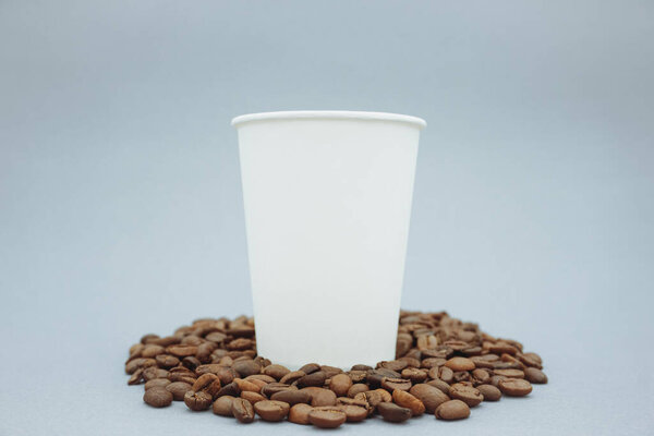 White paper cup mockup or mockup template. A simple clean paper cup. Coffee beans.