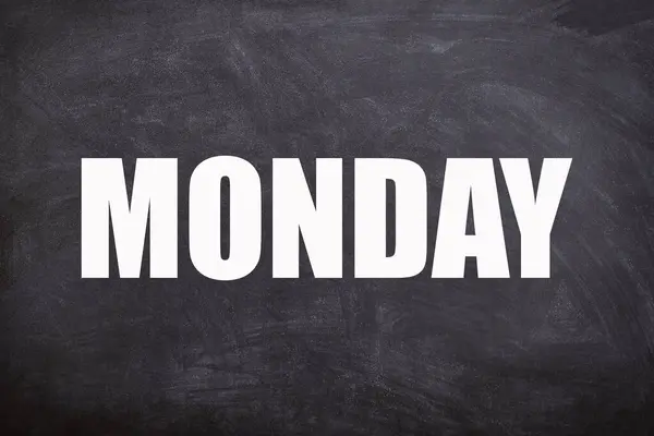 Monday text with blackboard background. And monday is the first day of the week.