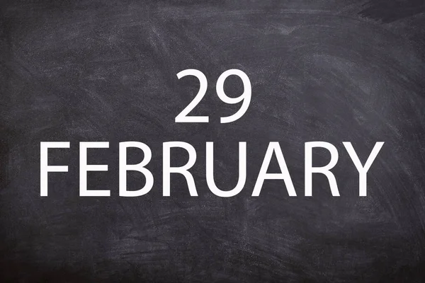 29 February text with blackboard background for calendar. And February is the second month of the year.