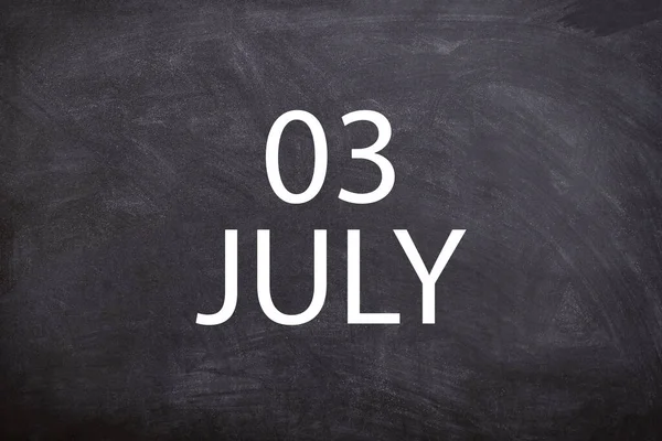 03 July text with blackboard background for calendar. And July is the seventh month of the year