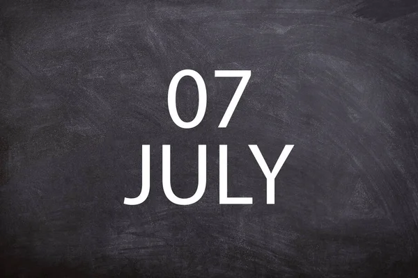 07 July text with blackboard background for calendar. And July is the seventh month of the year