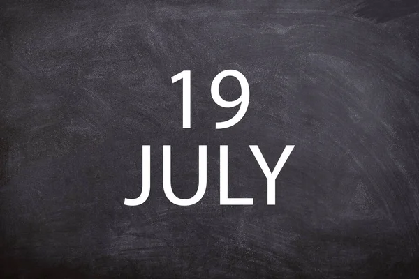 19 July text with blackboard background for calendar. And July is the seventh month of the year