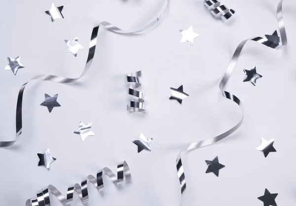 White Background Silver Serpentine Stars Concept Celebrating Birthday Newborn Party — Foto de Stock