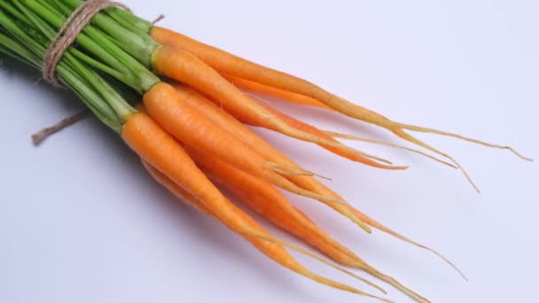 Rotating Bunch Young Carrots White Background High Quality Footage — Stock video