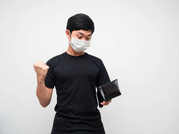 Portrait man wearing mask feeling happy show fist up while looking wallet in his hand on white background
