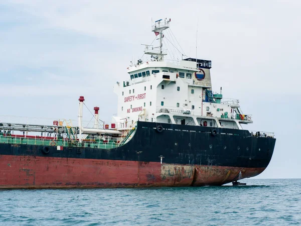 Large logistic ship in the ocean with unloading and cloudy on sky,Big Shipping boat transportation concept on the sea