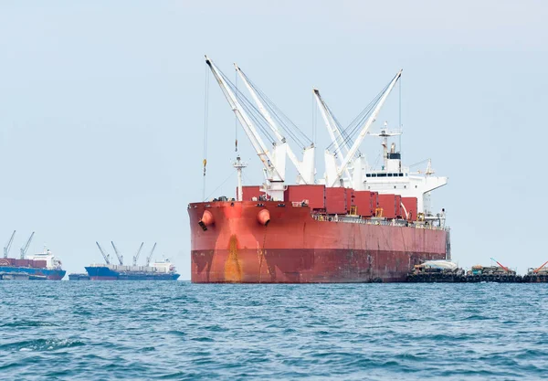 Large ship red color with big crane in the ocean landscape,Industrial boat in the sea logistic concept