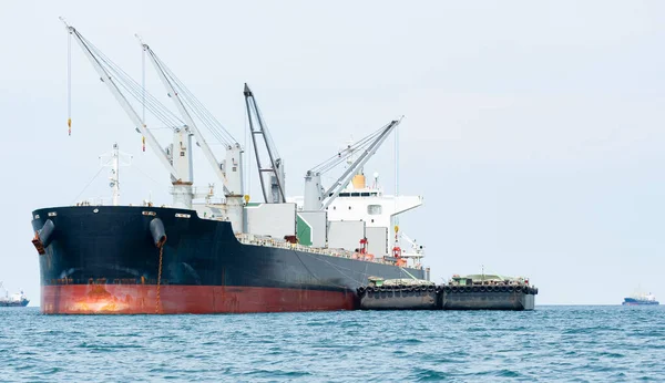 Crane in the industrial ship in the ocean blue water and blue sky landscape,Logistic and transportation ship concept in the sea