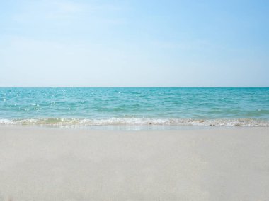 Kum ve deniz suyu kumsalda dalgalanıyor mavi okyanus mavi gökyüzü manzarası, deniz dalgaları kabarcık konsepti güneş ışığıyla güzel okyanus