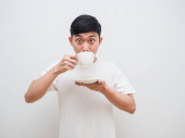 Man white shirt feel amazed with drink coffee in hand look at camera on white background