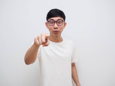 Asyalı adam gözlüğü parmağınla beyaz gömleğini işaret ediyor.