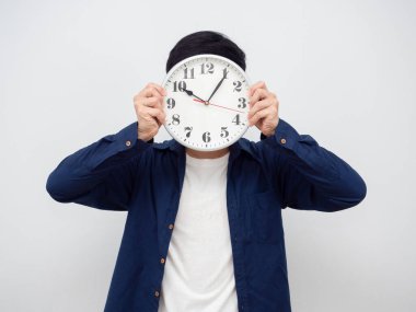 Man holding analog clock close his face portrait