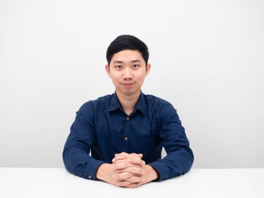 Masada oturan yakışıklı, kendine güvenen, gülümseyen ve sana bakan adam.