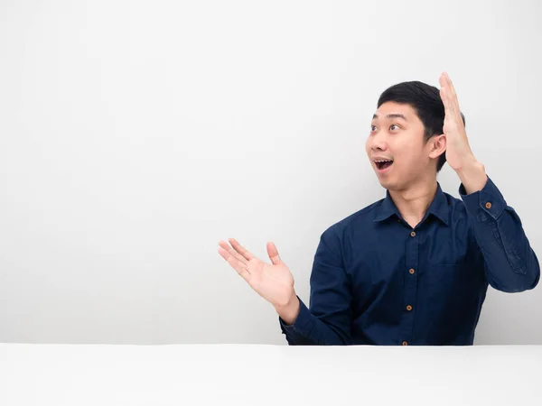 stock image Asian man feeling amazed showing hand up and looking at copy space white background