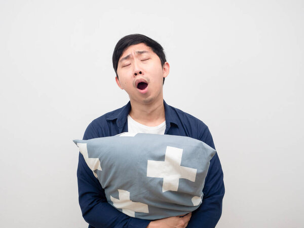 Man hug pillow and yawn feeling sleepy and lazy