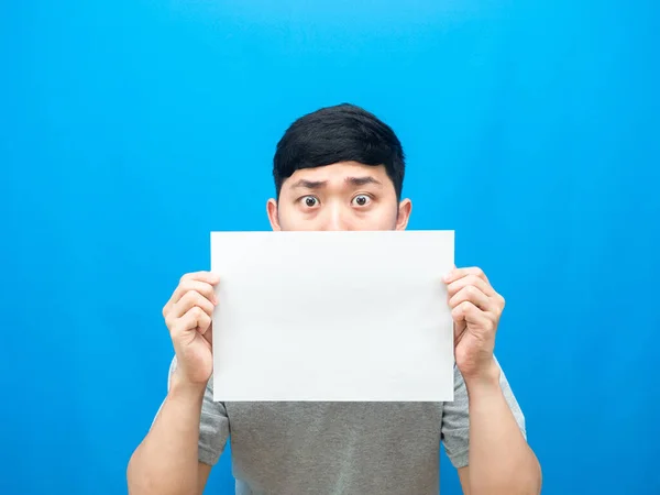 Man Holding Empty Sheet Close His Face Blue Background — 图库照片