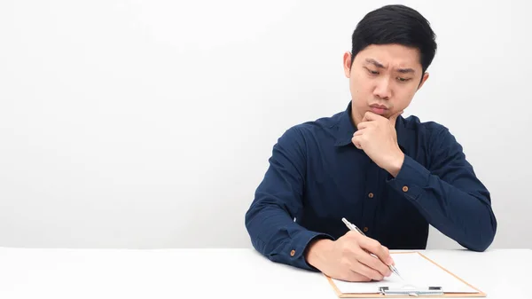Man Writing Document Board Thinking Something Table Copy Space — Stockfoto