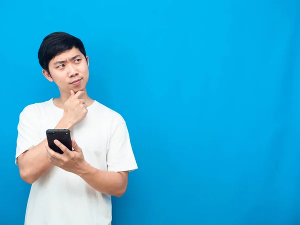 Young Man White Shirt Holding Mobile Phone Gesture Thinking Looking — ストック写真