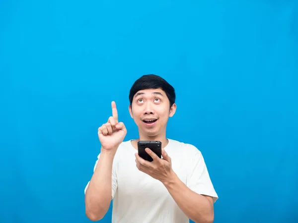 Cheerful Man Holding Cellphone Point Finger Copy Space Blue Background — Stockfoto