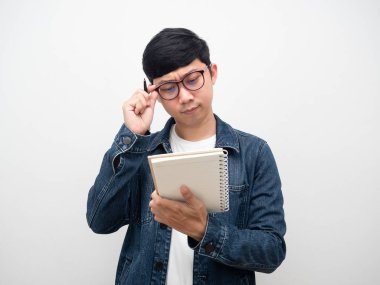 Man jeans shirt wearing glasses reading his diary