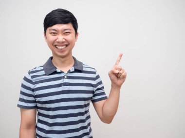 Neşeli adam çizgili gömlek parmağıyla fotokopi uzayı işaret ediyor.