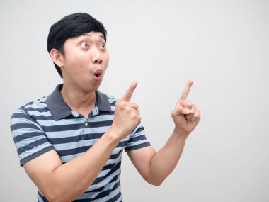 Young man striped shirt excited double point finger at copy space