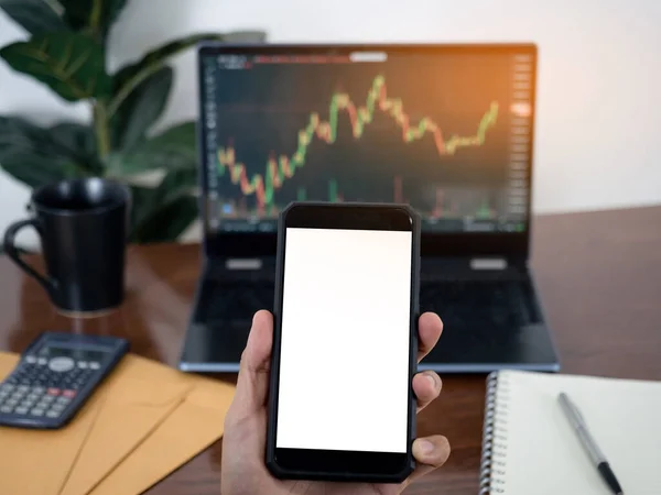Hand Holding Smartphone White Screen Front Laptop Financial Graph Business —  Fotos de Stock